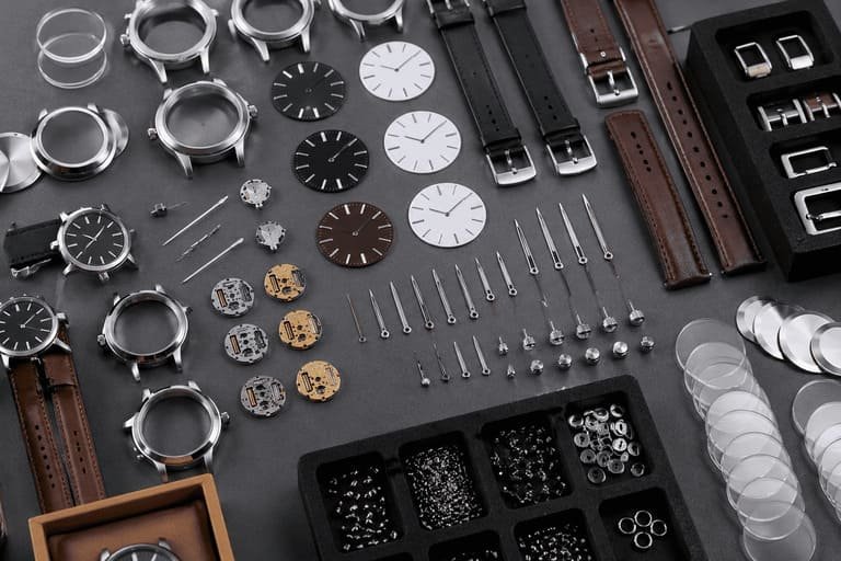 A collection of watch components laid out on a table